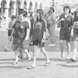 Crowded square with buildings and people in Venice, Italy.