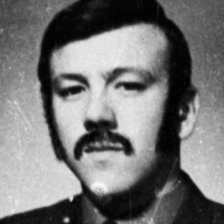Here's a brief summary of the image: Portrait of a man in a military uniform.