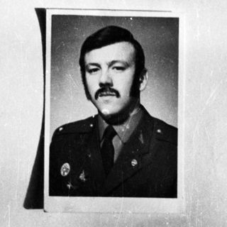 Here's a brief summary of the image: Portrait of a man in a military uniform.