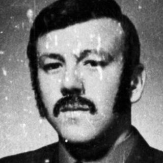Here's a brief summary of the image: Moustached man in military uniform, displayed in a photo.
