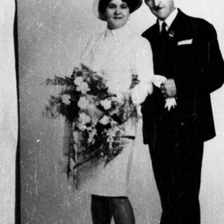 Black and white photo of a couple in formal wear.