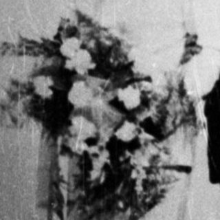 Black and white photo of a couple in formal wear.