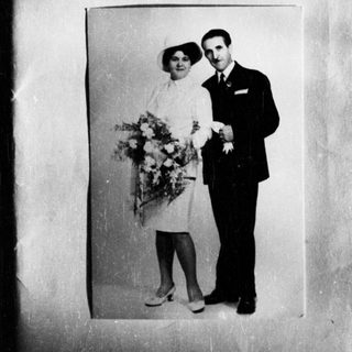 Black and white photo of a couple in formal wear.