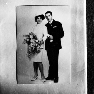 Black and white photo of a couple in formal wear.