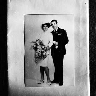 Black and white photo of a couple in formal wear.