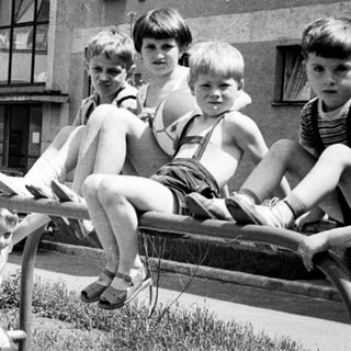 Children playing on a seesaw in a playground.