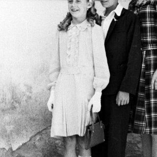 Family portrait, likely taken in a rural or older setting.