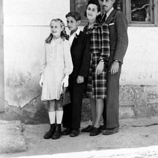 Family portrait, likely taken in a rural or older setting.