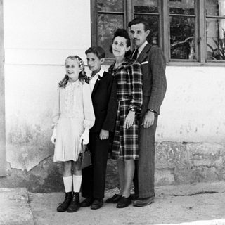 Family portrait, likely taken in a rural or older setting.