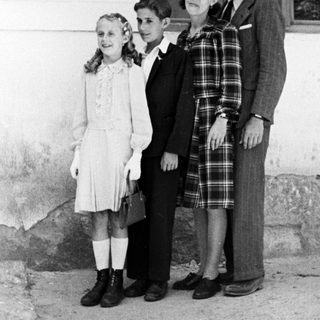 Family portrait, likely taken in a rural or older setting.