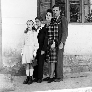Family portrait, likely taken in a rural or older setting.