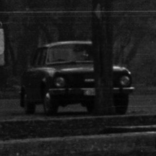 Black and white photo of people in a snowy park.