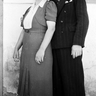 A couple poses for a black and white portrait.