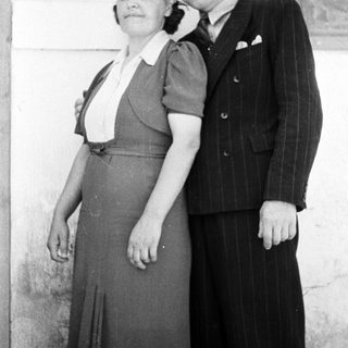 A couple poses for a black and white portrait.