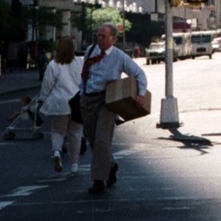 Here's a brief summary of the image: New York City street with the Empire State Building visible.