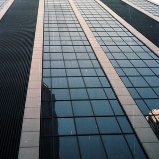 A tall building's exterior, viewed from a low angle.