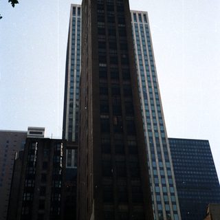 Tall, historic building rises against a clear blue sky.