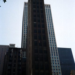 Tall, historic building rises against a clear blue sky.