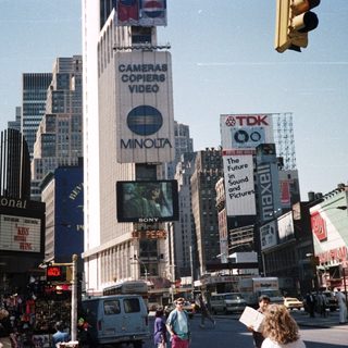 Times Square street scene with prominent advertising displays.