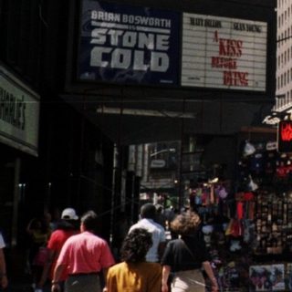 Times Square street scene with prominent advertising displays.