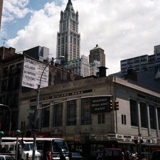 Bank building and a tall building in a city street.