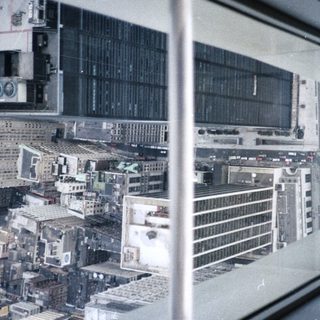 View from a high window overlooking a city skyline.