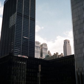 Here's a brief summary of the image: Modern architecture and cityscape view in a public plaza.