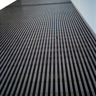 Tall building with vertical lines, viewed from a low angle.