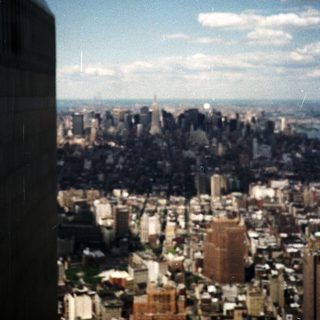 Aerial view of New York City skyline with clouds.