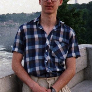 Man poses near Niagara Falls with a view.