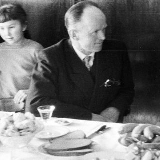 Black and white photo of a family at a table.