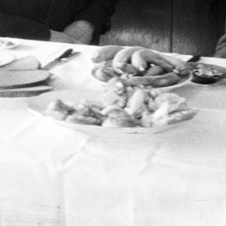 Black and white photo of a family at a table.