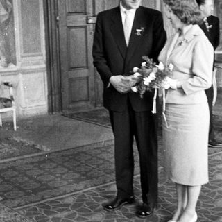Black and white photo of a couple standing after a wedding.