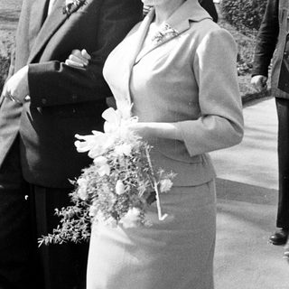 Couple exiting a building, likely a wedding.