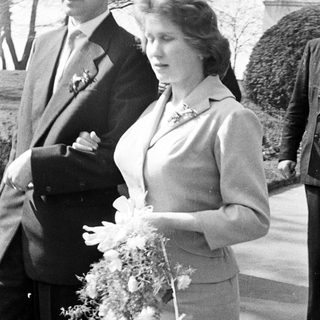 Couple exiting a building, likely a wedding.