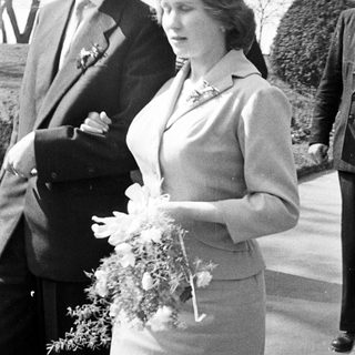 Couple exiting a building, likely a wedding.