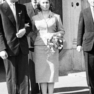 Black and white photo of a wedding party outside.
