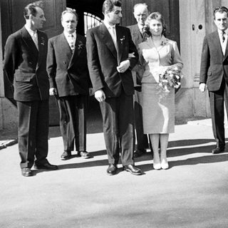 Black and white photo of a wedding party outside.