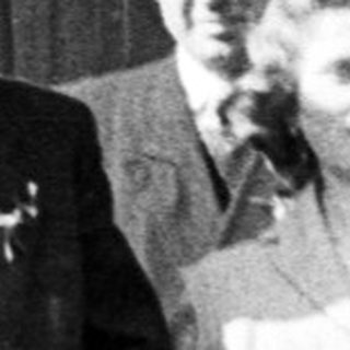 Black and white photo of a wedding party outside.