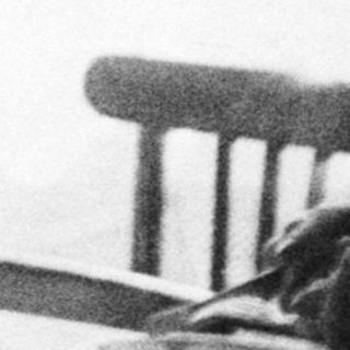 Two people seated at a table, appearing to eat.