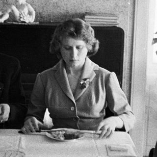 Black and white photo of three people at a table.