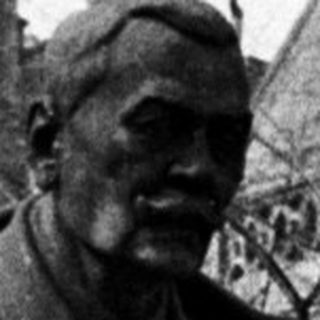 Black and white photo of a statue and building.
