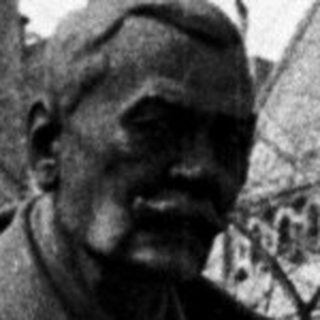 Black and white photo of a statue and building.