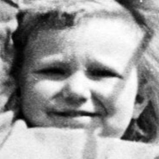 Black and white photo of a child on a swing.
