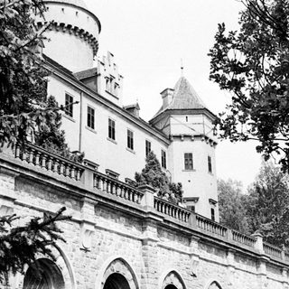 Black and white photo of a castle with a tower.
