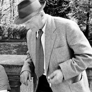 Man and woman outdoors, possibly interacting, in black and white.