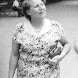 Couple walking in a park, vintage black and white photograph.