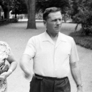 Couple walking in a park, vintage black and white photograph.