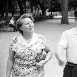 Couple walking in a park, vintage black and white photograph.