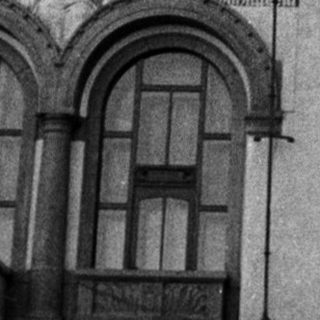 Here's a brief summary of the image: Elaborate facade of a historic building with statues.